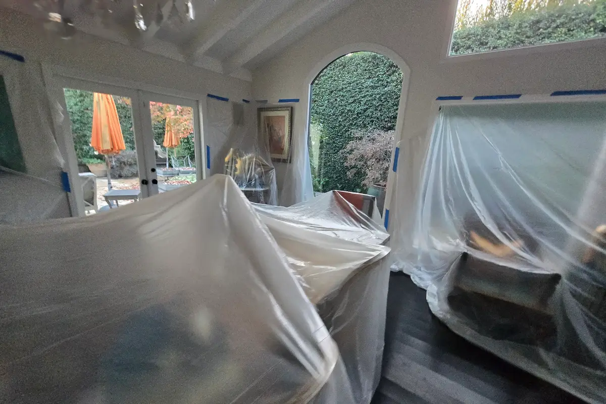 Protected furnishings and plastic containment during Beverly Hills water damage restoration work
